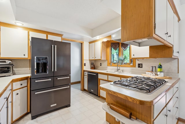 141 Lakeshore Dr, Big Lake, MN 55309 - kitchen featuring high end black refrigerator, dishwasher, a sink, light countertops, and stainless steel gas stovetop