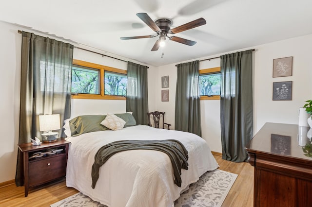 141 Lakeshore Dr, Big Lake, MN 55309 - bedroom with multiple windows, light wood-style flooring, and a ceiling fan