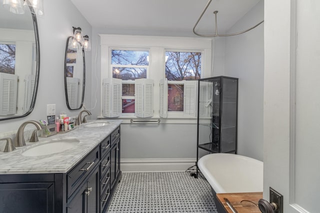 bathroom featuring vanity and a tub to relax in