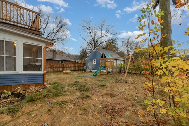 view of yard with a sunroom and a balcony