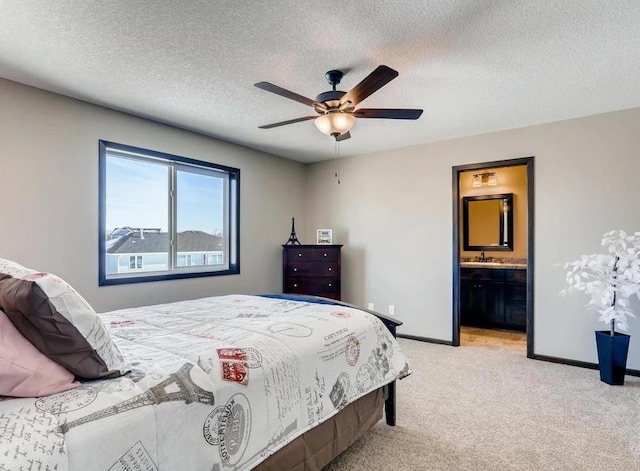 bedroom with light carpet, ensuite bath, sink, a textured ceiling, and ceiling fan