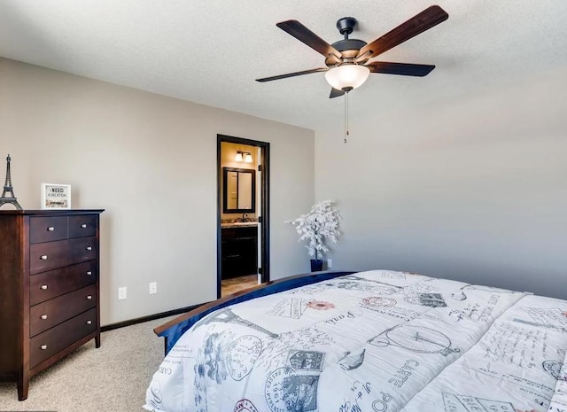 carpeted bedroom with ceiling fan, a textured ceiling, and ensuite bath