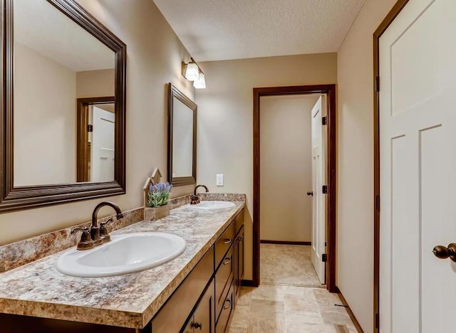 bathroom with vanity and a textured ceiling