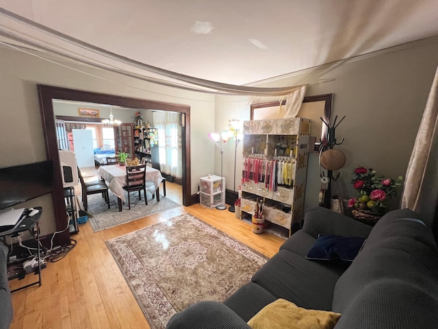 living room featuring hardwood / wood-style flooring and an inviting chandelier