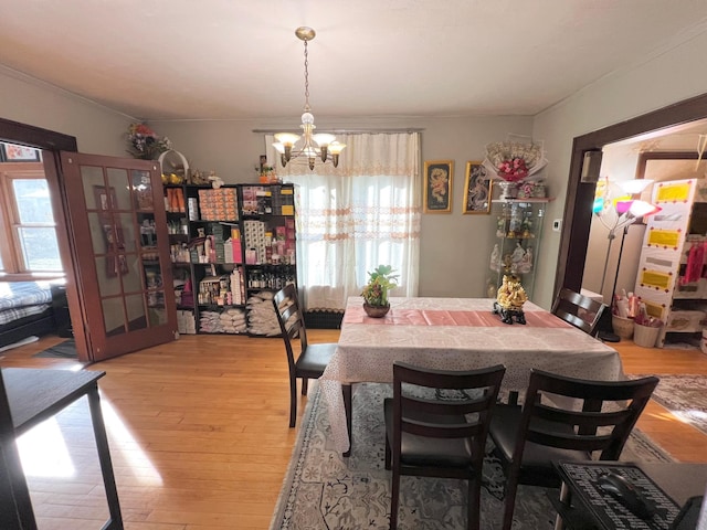 dining area with a chandelier and light wood-type flooring