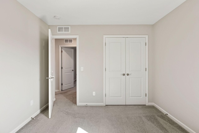 unfurnished bedroom featuring carpet floors, visible vents, and baseboards