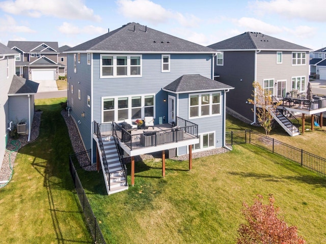 back of property featuring a yard, stairway, fence private yard, and a residential view