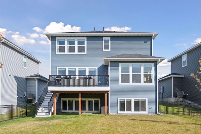 back of house featuring stairway, fence, a deck, a yard, and central AC