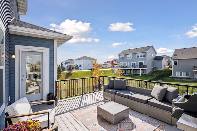 wooden deck with outdoor lounge area and a residential view