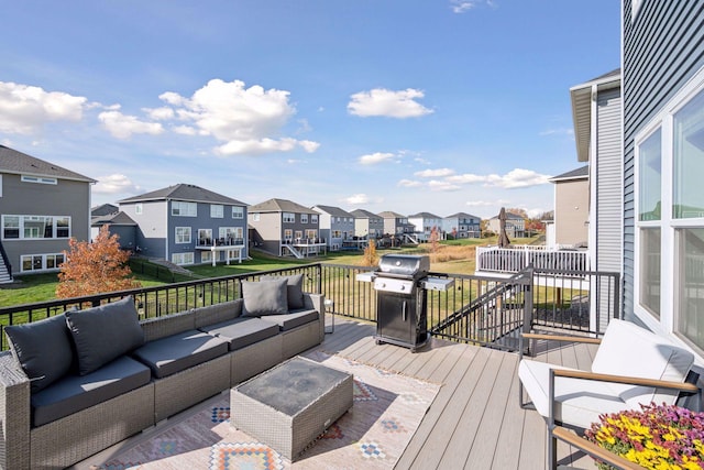 wooden terrace featuring a residential view, an outdoor hangout area, a lawn, and area for grilling