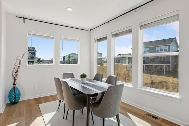 dining area with recessed lighting, visible vents, baseboards, and wood finished floors