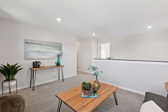 living area with carpet, baseboards, and recessed lighting