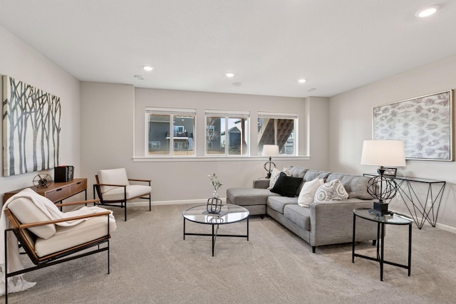 living room featuring recessed lighting, baseboards, and light colored carpet