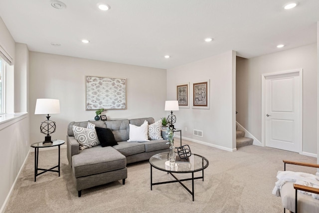 living room with recessed lighting, visible vents, light carpet, and stairs