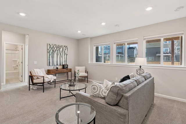 living room with recessed lighting, light carpet, and baseboards