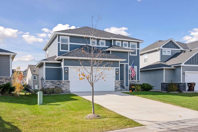 view of front of house with driveway, stone siding, roof with shingles, and a front yard