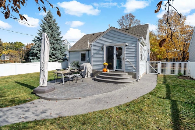 back of property featuring a patio and a lawn