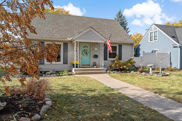 bungalow-style house featuring a front lawn