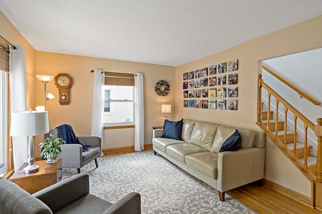 living room featuring a textured ceiling and hardwood / wood-style floors