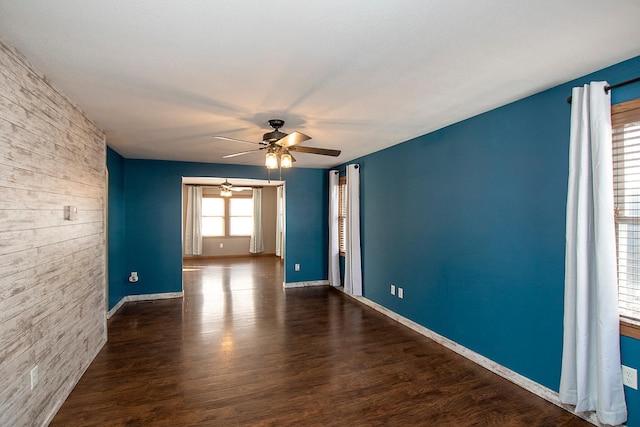 spare room featuring ceiling fan and dark hardwood / wood-style flooring