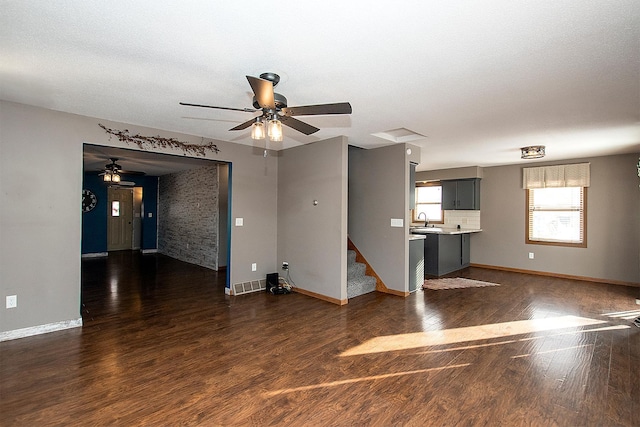 empty room with ceiling fan, dark wood-type flooring, and sink