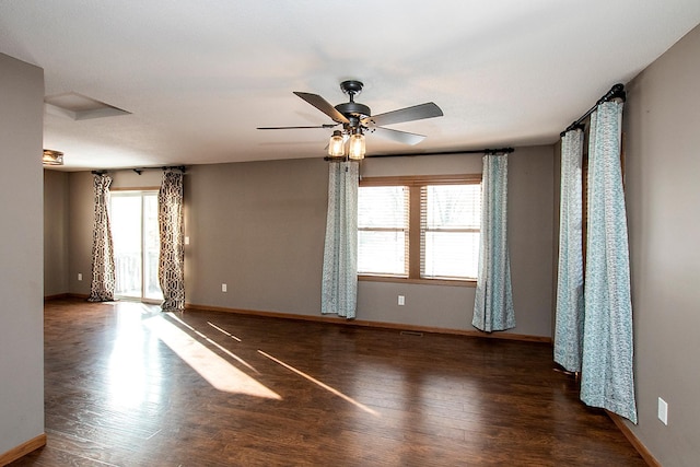 unfurnished room with ceiling fan and dark wood-type flooring