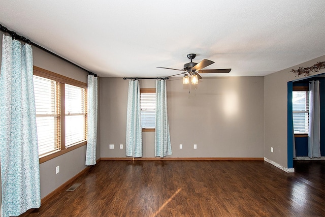 unfurnished room with ceiling fan and dark hardwood / wood-style flooring