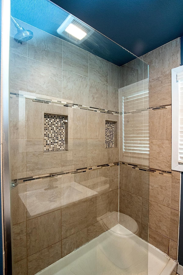 bathroom with tiled shower