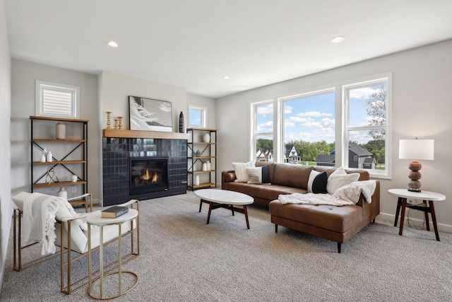 living room featuring carpet and a fireplace