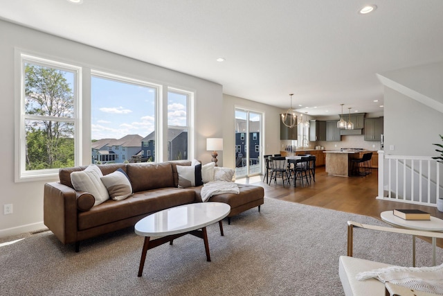 living room featuring light hardwood / wood-style flooring and an inviting chandelier