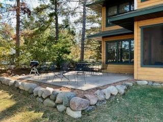 view of patio / terrace featuring a sunroom