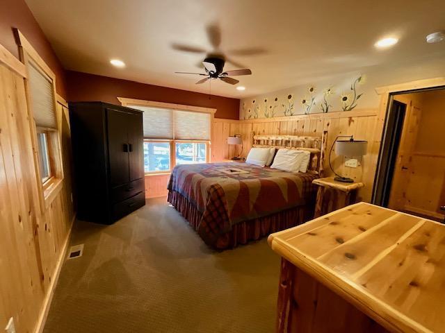 bedroom featuring light colored carpet and ceiling fan