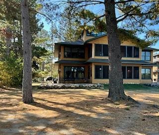 rear view of property featuring a chimney