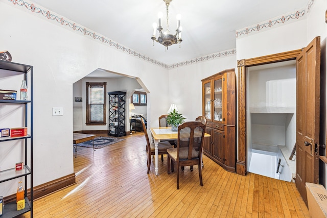 dining room featuring a notable chandelier and wood-type flooring