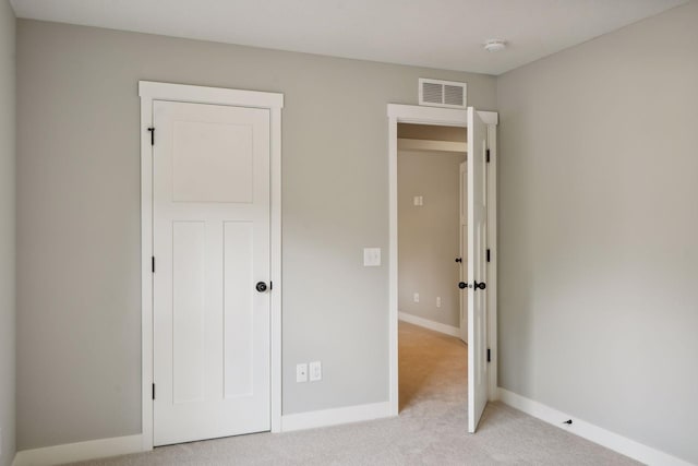 unfurnished bedroom featuring light carpet