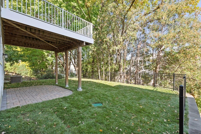 view of yard with a patio, a wooden deck, and central air condition unit