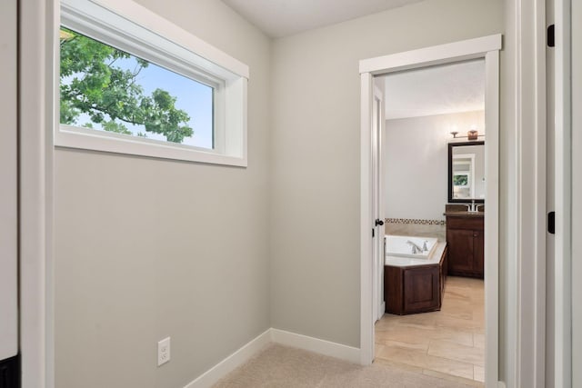 bathroom with hardwood / wood-style floors and a tub to relax in