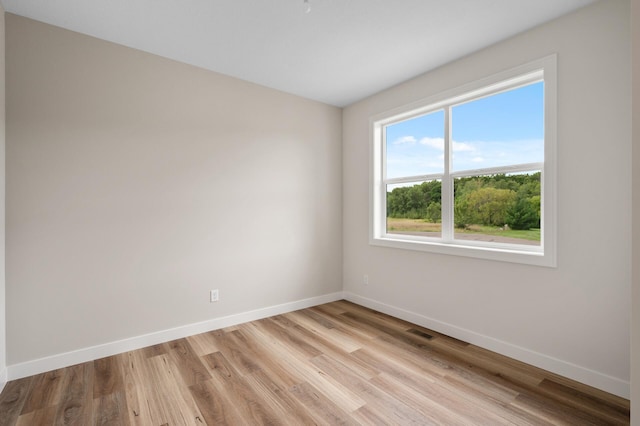 spare room featuring light wood-type flooring