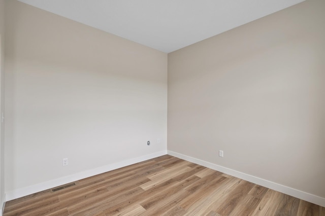 spare room featuring light wood-type flooring