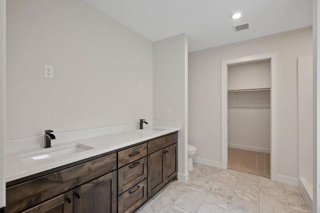 bathroom featuring toilet and vanity