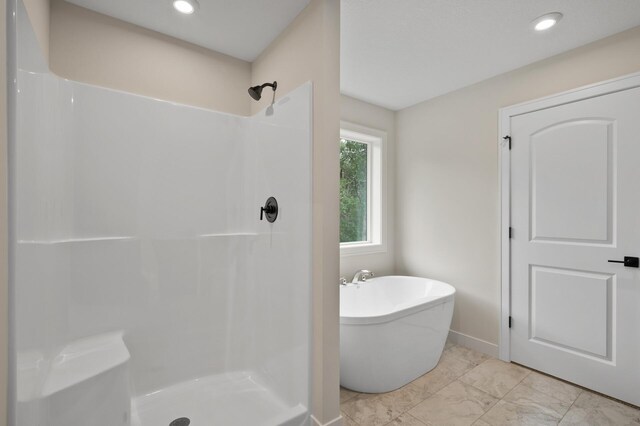 bathroom with shower with separate bathtub