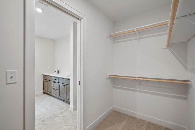 walk in closet featuring sink