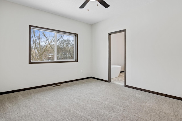 unfurnished room with light colored carpet and ceiling fan