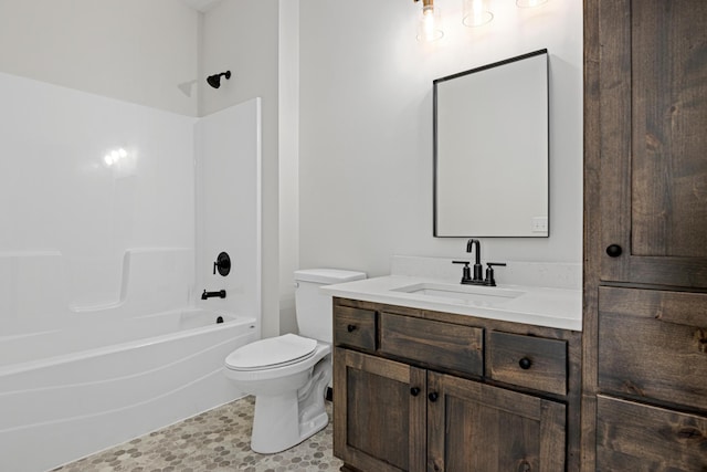 full bathroom featuring toilet, vanity, and tub / shower combination