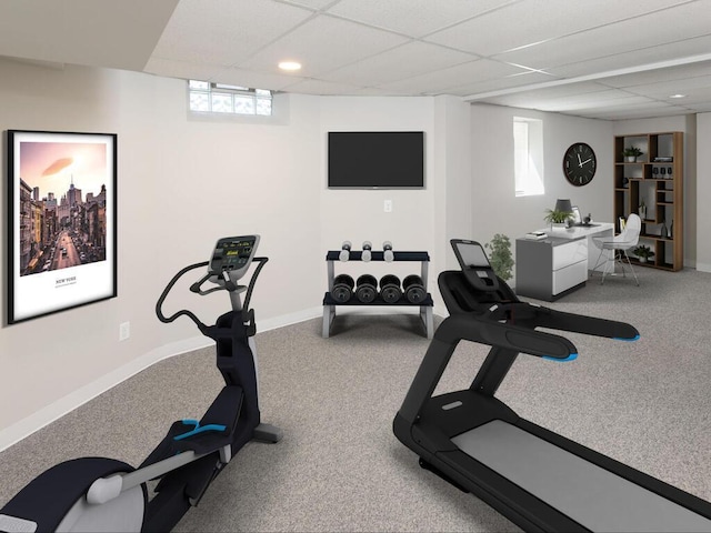 workout room featuring carpet floors, a paneled ceiling, and a wealth of natural light