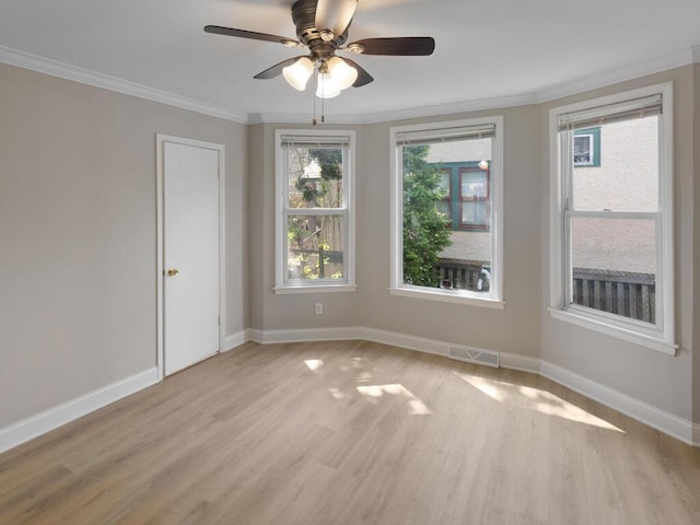 spare room with ornamental molding, light hardwood / wood-style floors, and ceiling fan