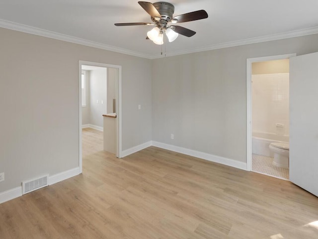 spare room with crown molding, light hardwood / wood-style floors, and ceiling fan