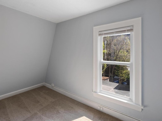 unfurnished room featuring carpet flooring and lofted ceiling