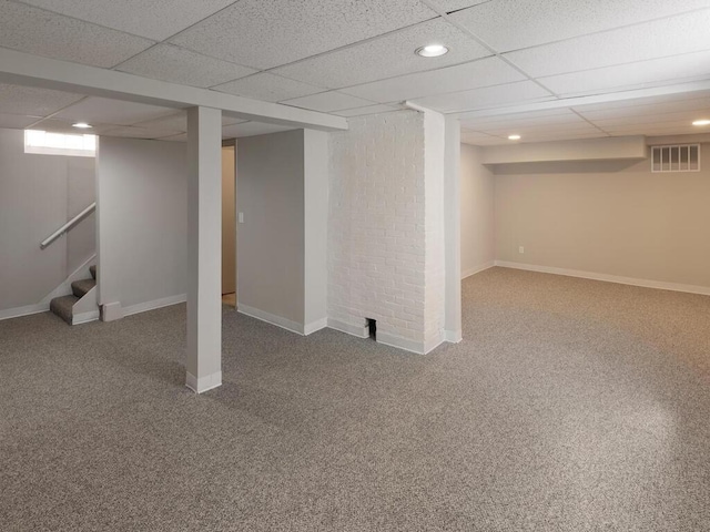 basement featuring carpet floors and a drop ceiling