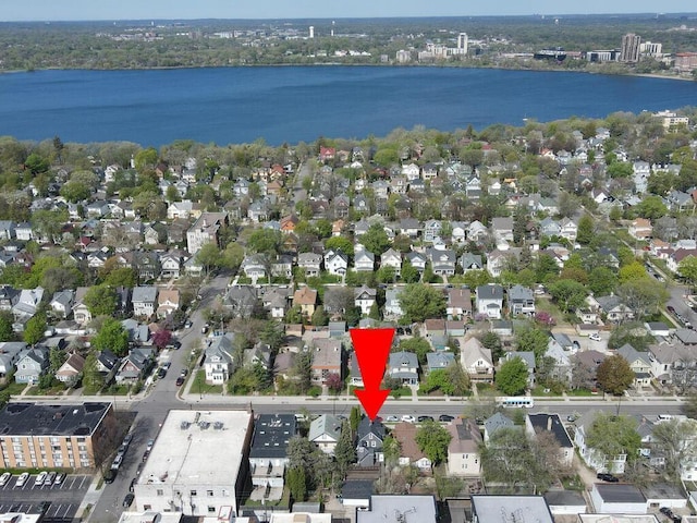 birds eye view of property with a water view